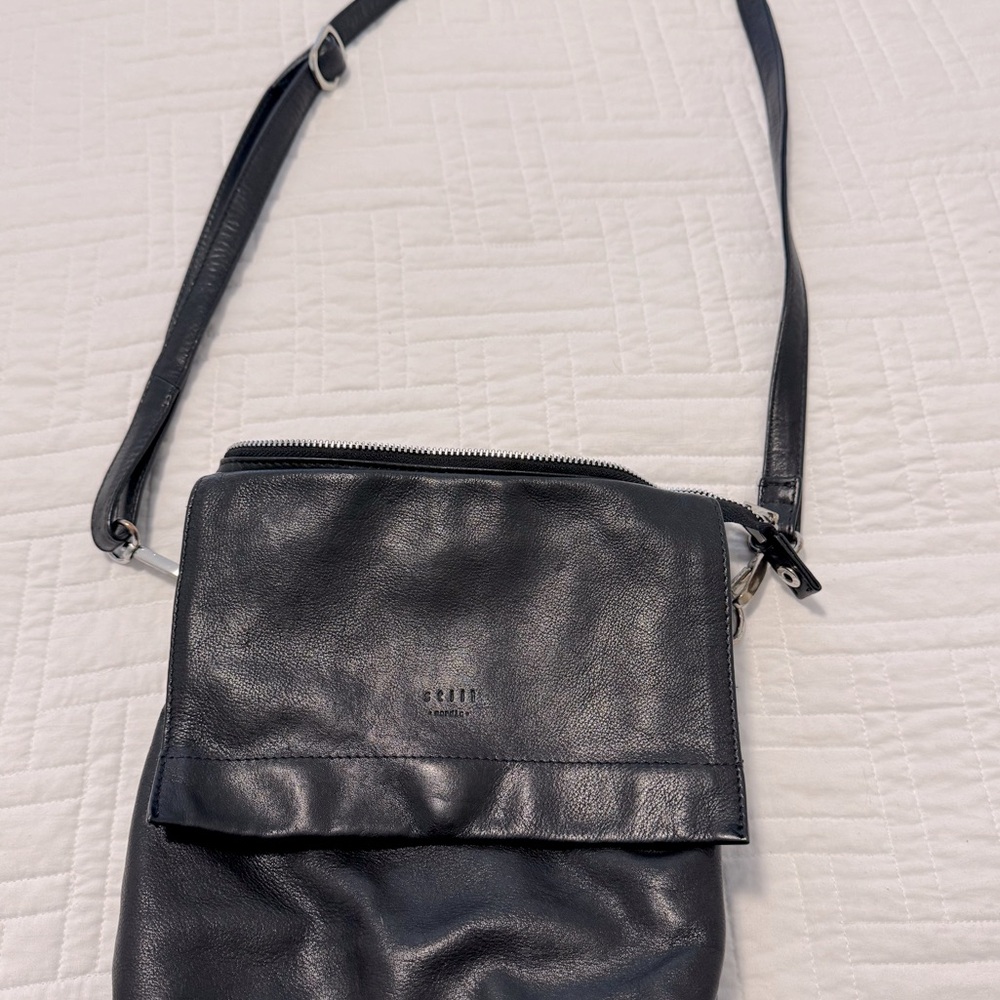 Black leather crossbody. Brand is Still Nordic